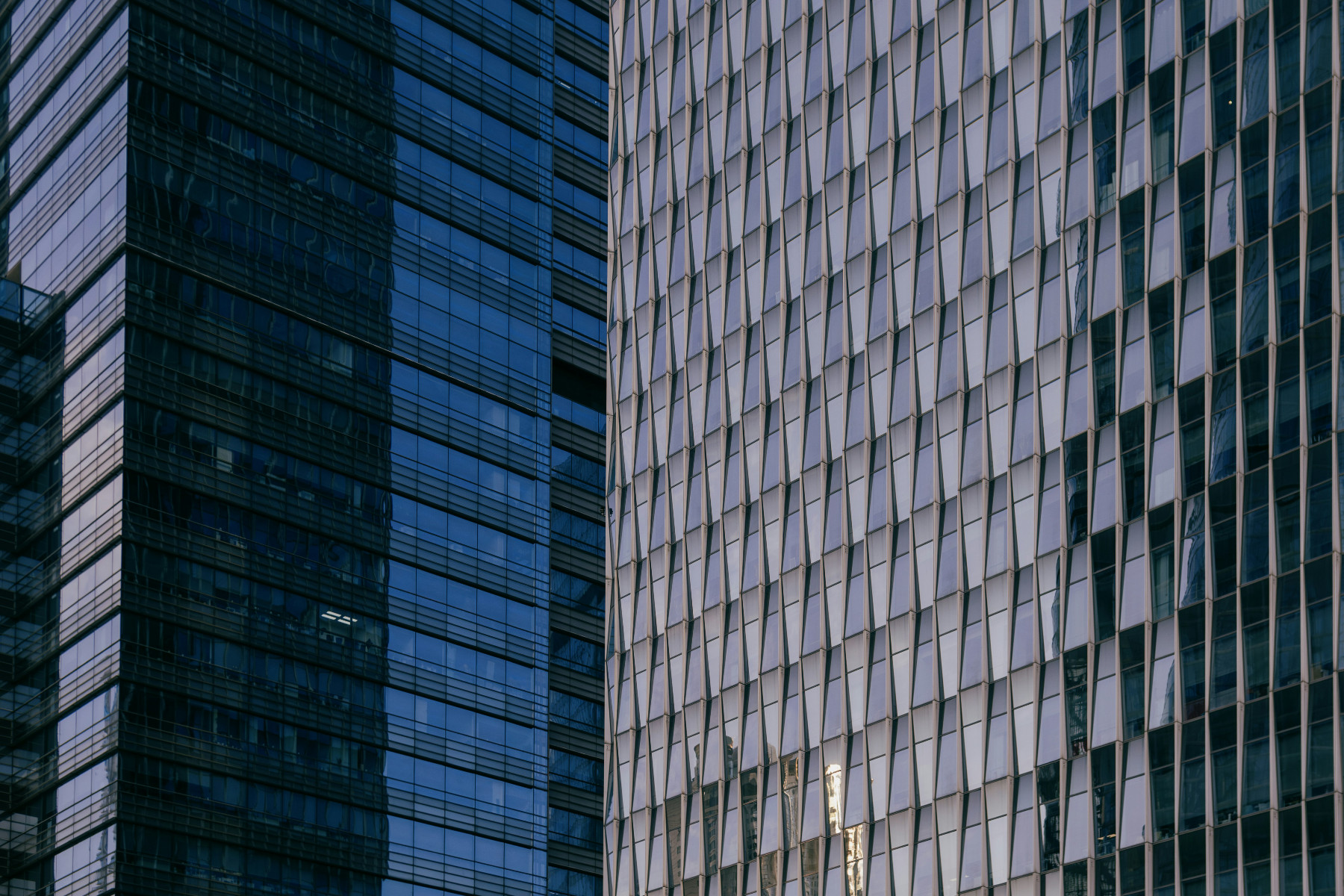 Glass curtain-wall facades of two office towers
