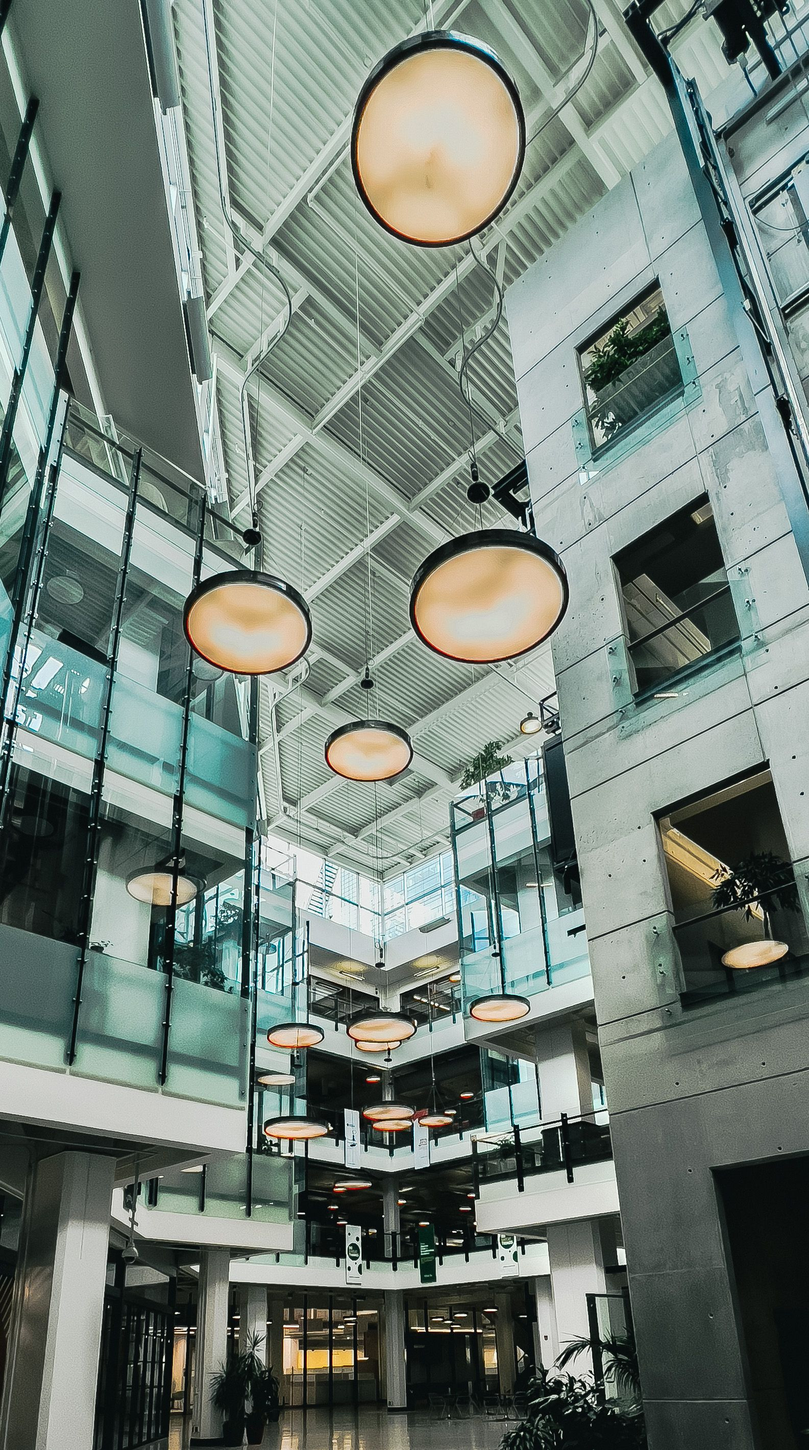 Pendant lights along a modern hallway
