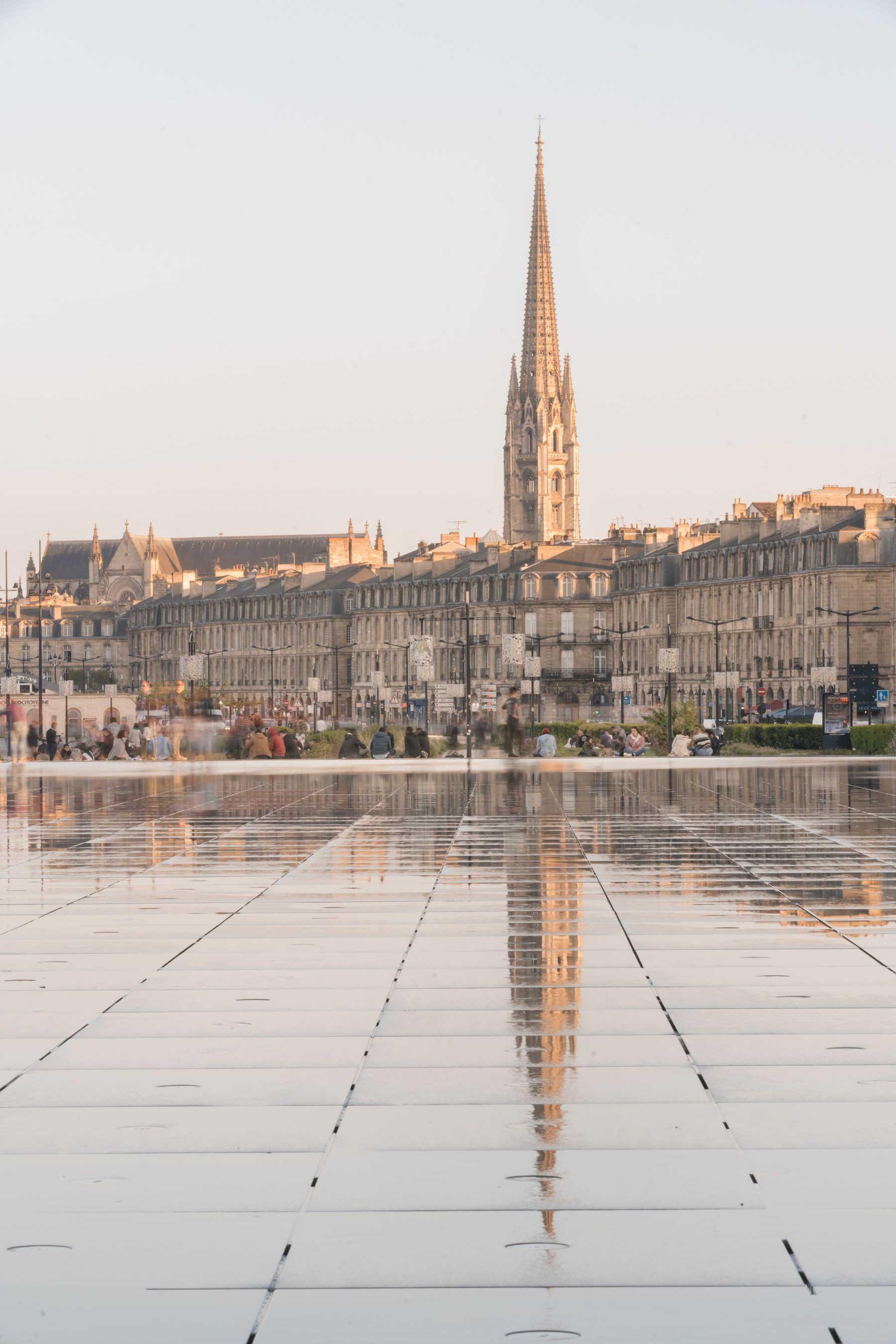 Bordeaux waterfront with the Saint-Michel spire at dusk