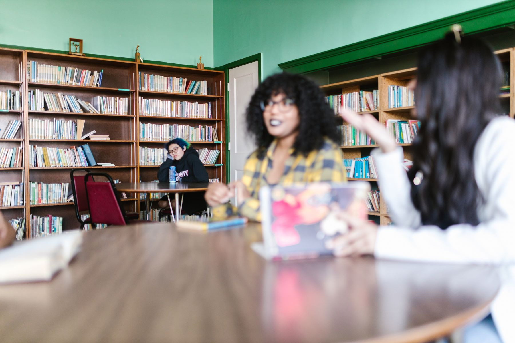 Students working together at a table in a library
